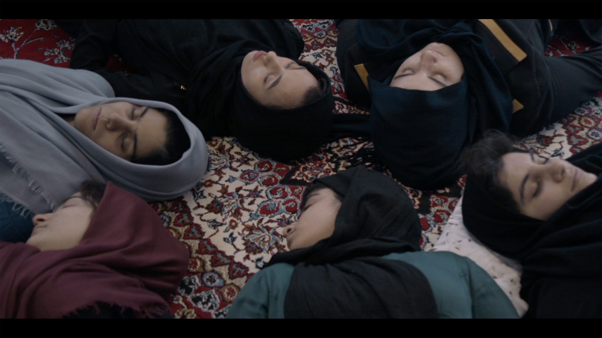 Girls in Iranian filmmaker Mehrdad Oskouei's Sunless Shadows (2019) which shows a group of girls in a reformatory lying down on a carpet during a meditation session